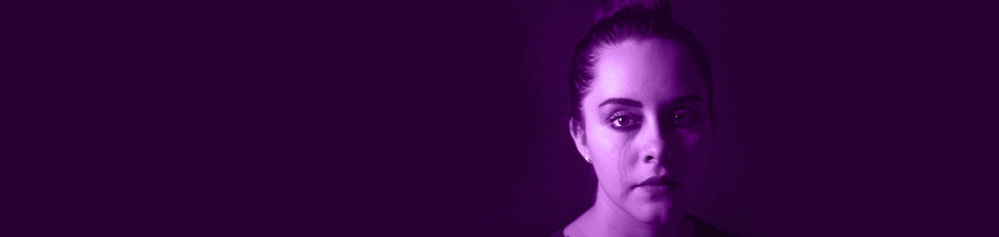 Girl staring straight into you on a dark purple background