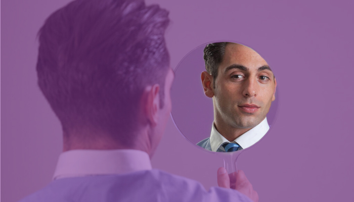 Man looking at himself pleasingly in the mirror